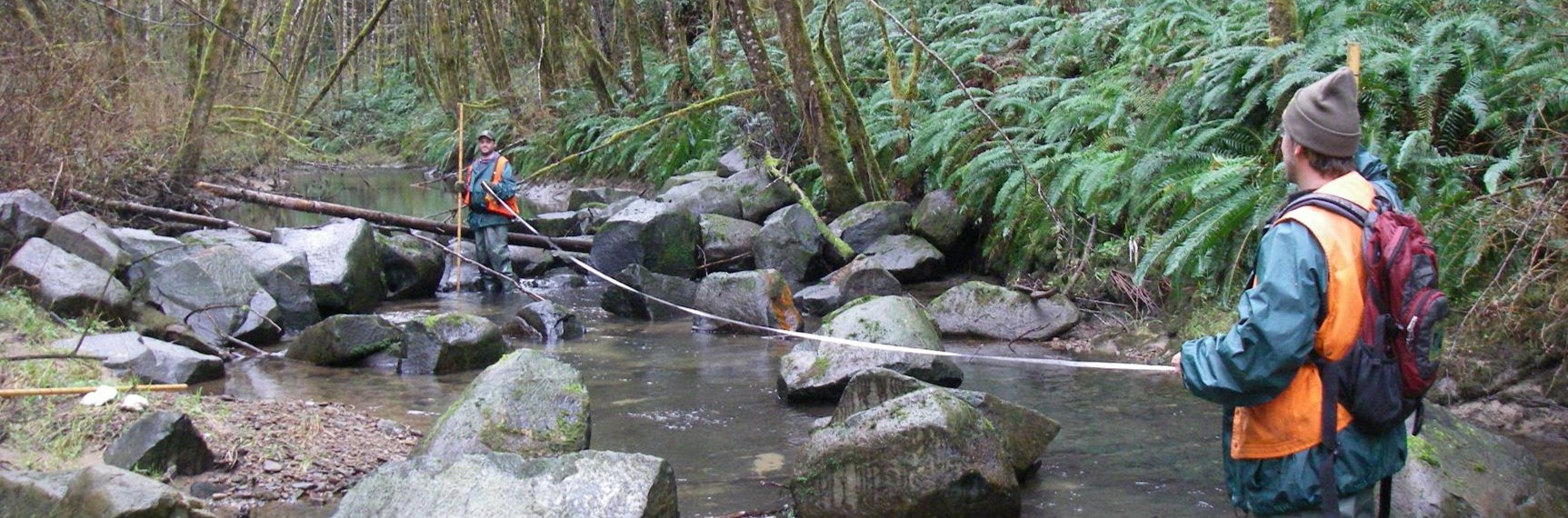 Two surveyors measure a habitat unit with new Boulder placements